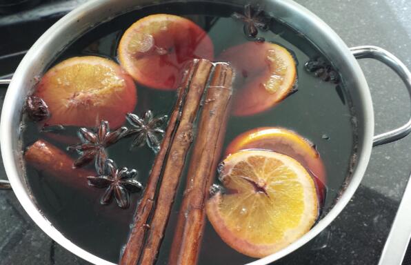 Pan full of spices and fruit with wine for mulled wine